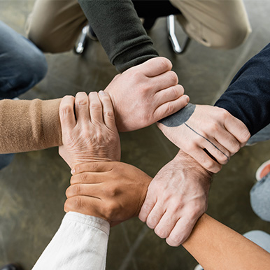 Group with hands clasped on each others wrist
