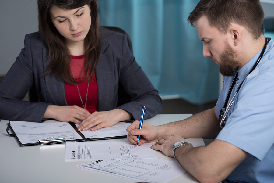 Innovative Rehabilitation Strategies, Hospital manager talking with medic in doctor's office