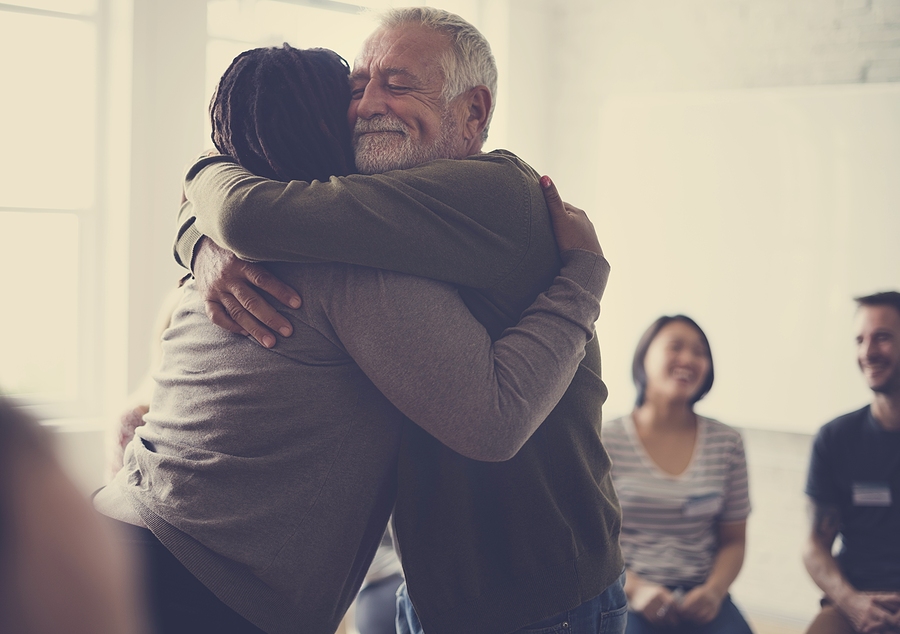 Old guy hugging a woman for being an Inpatient to Outpatient Rehab